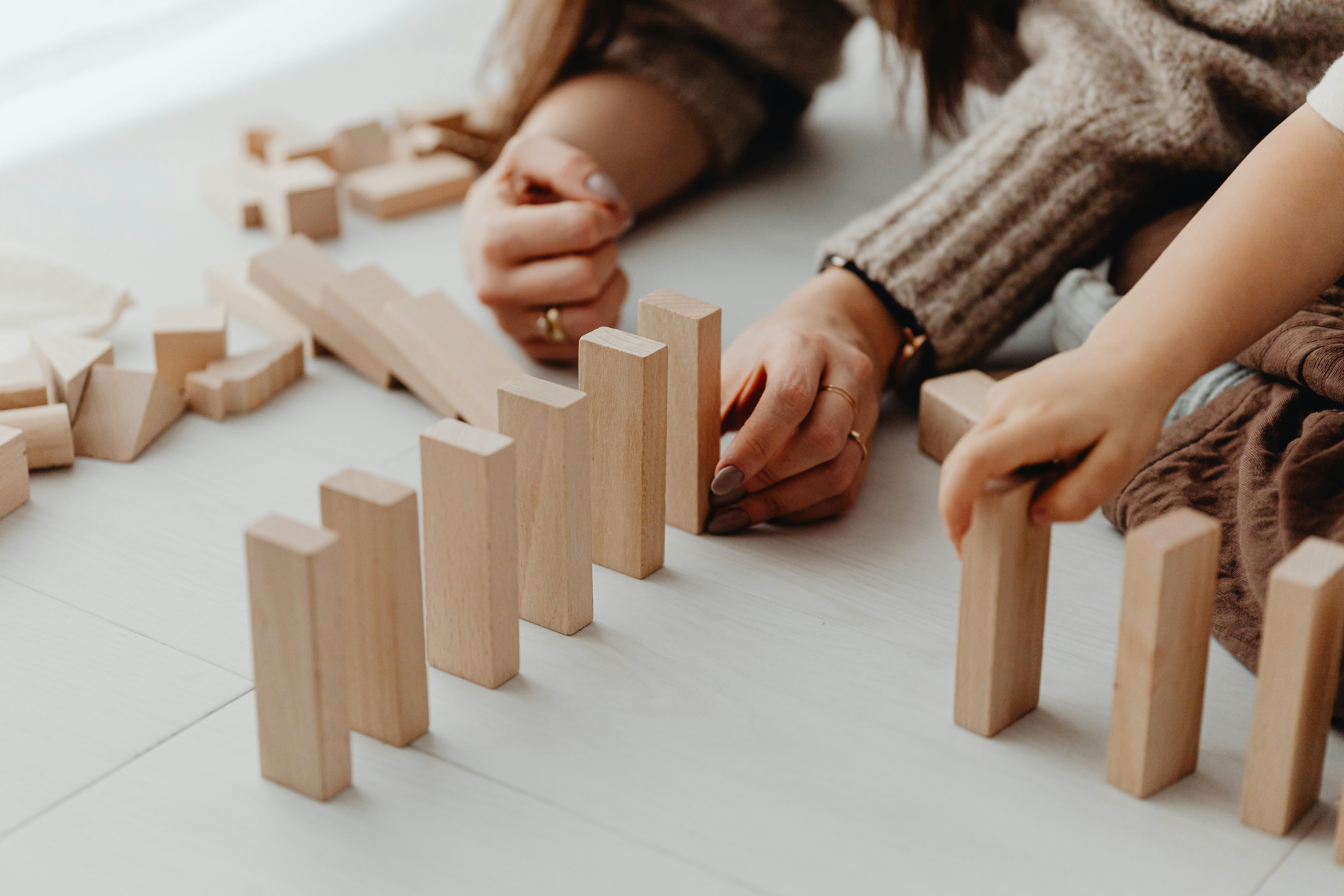Toddlers playing with colorful building blocks in a bright classroom
