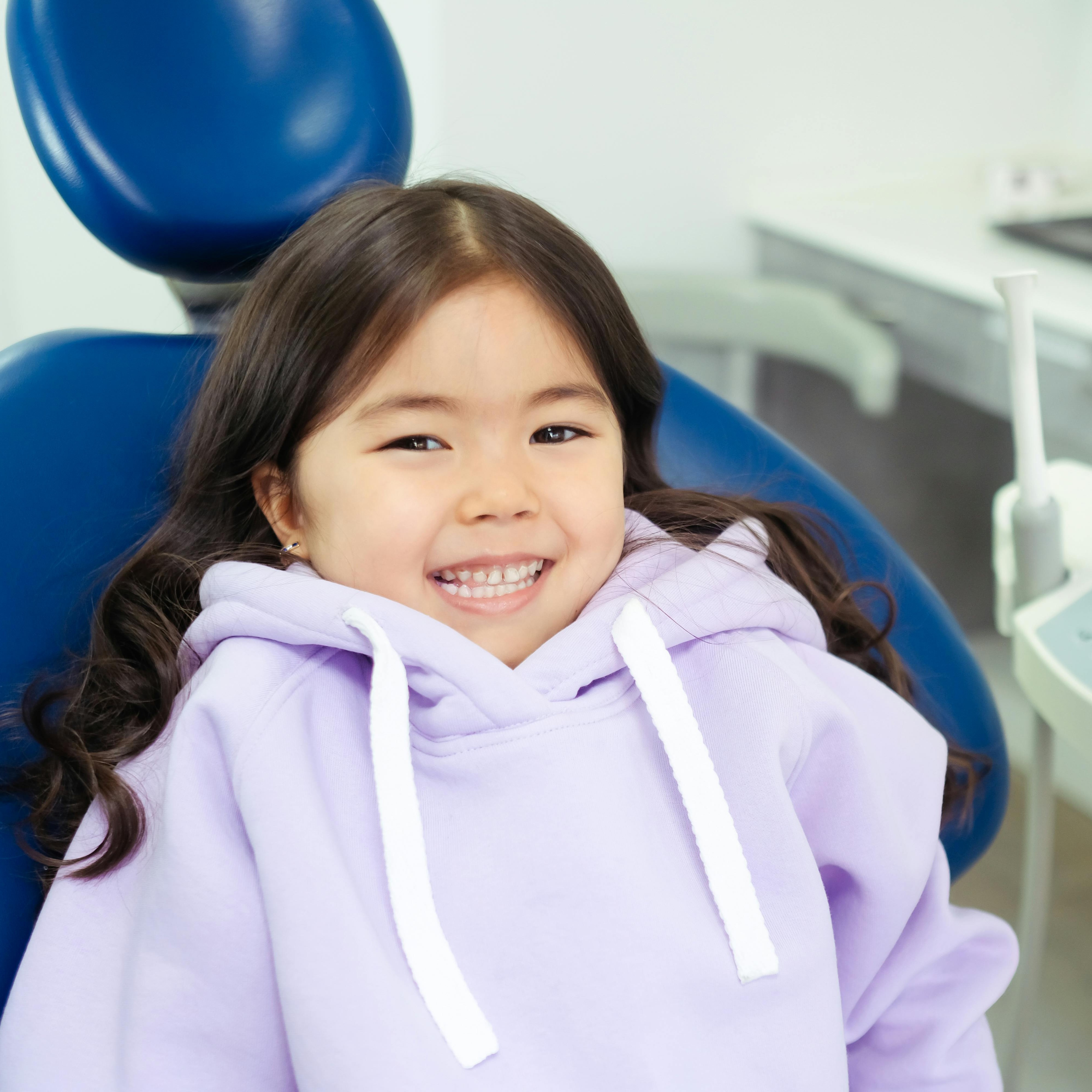 Young patient smiling comfortably in a bright Summit Dental treatment chair