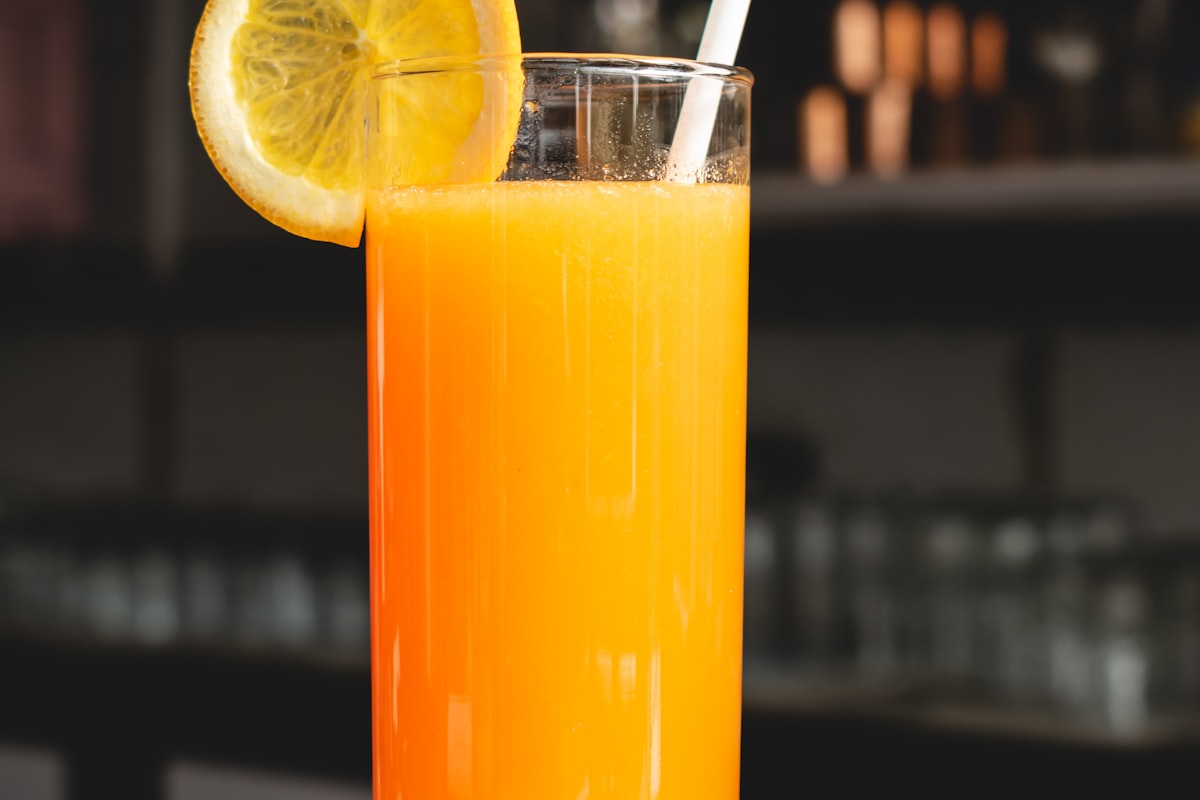 Fresh orange juice glass with citrus garnish