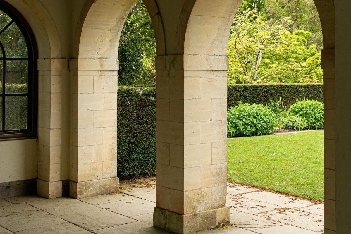 Terraced landscape design with native limestone walls and wildflower meadow in Austin