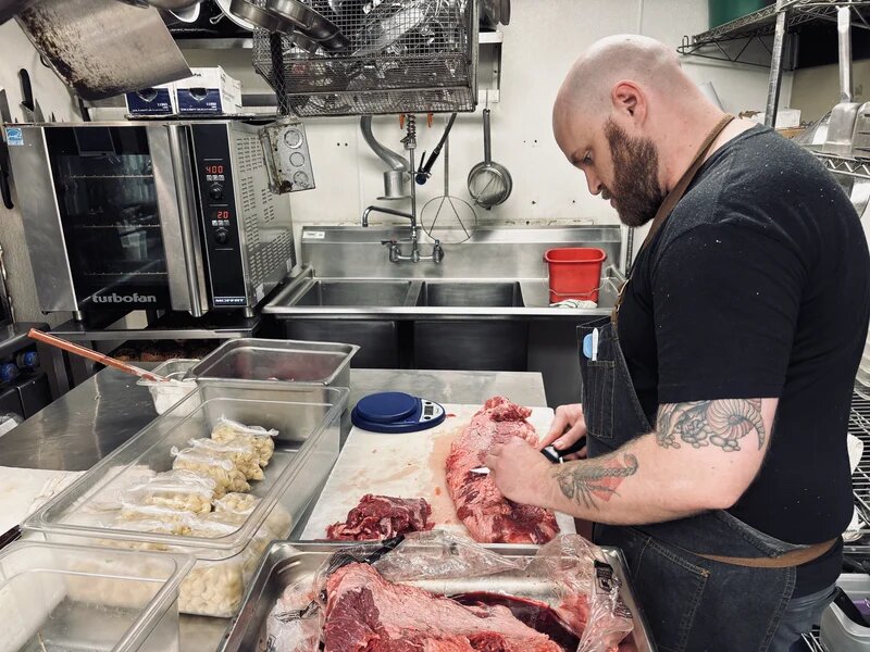 Chef preparing authentic Oaxacan dishes in the La Casa del Sol kitchen