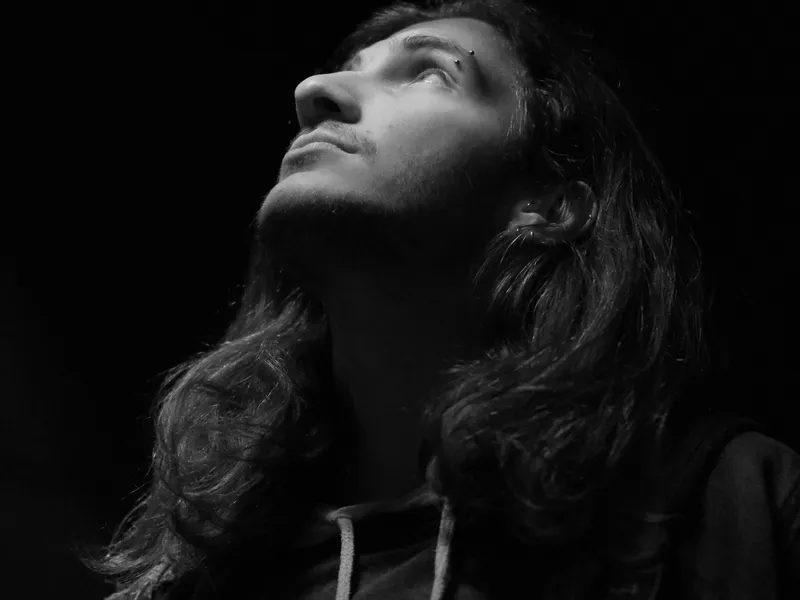 Moody portrait in natural window light with film grain texture