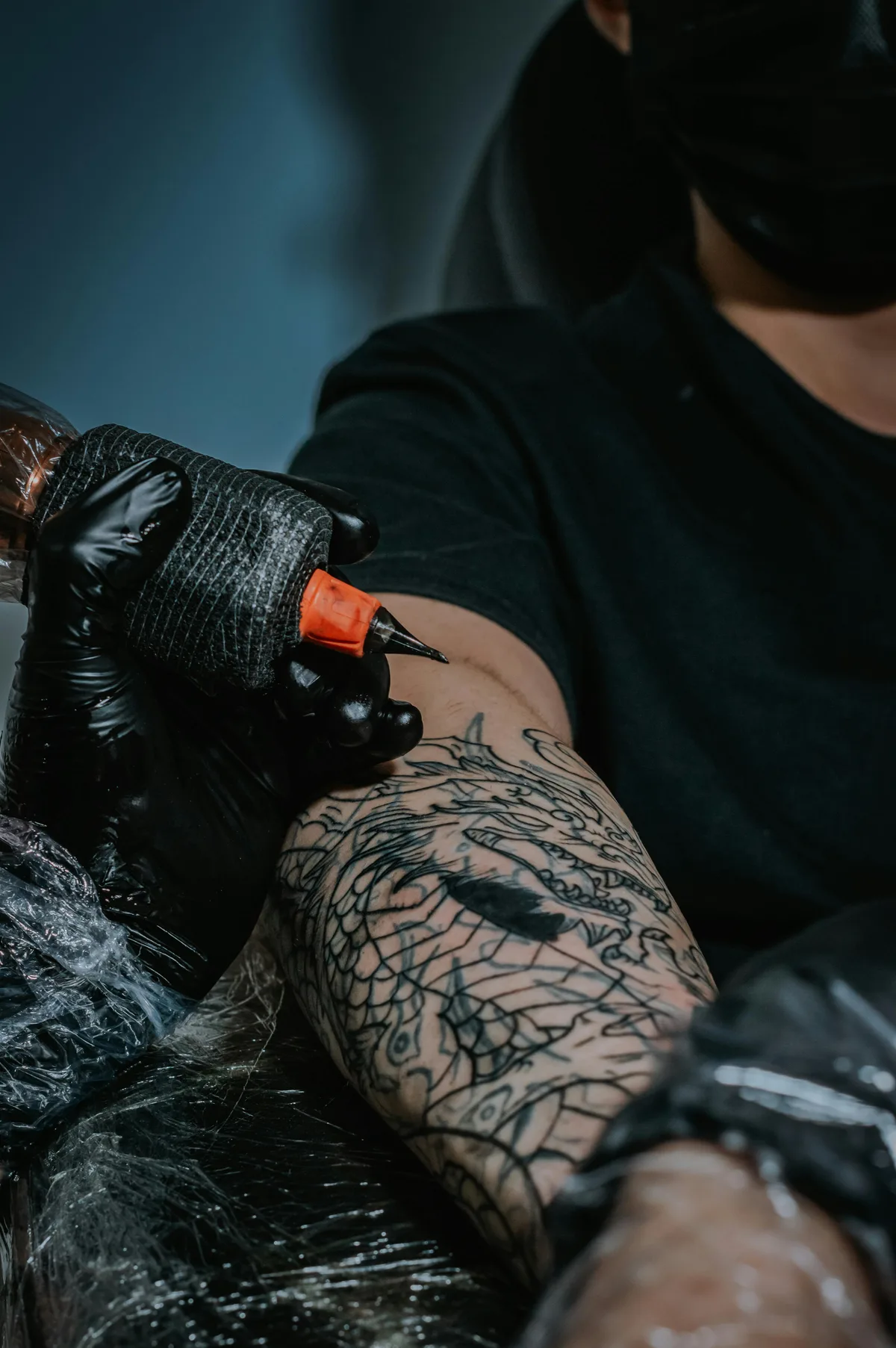 Large blackwork sleeve tattoo showing high-contrast solid ink and intricate negative space