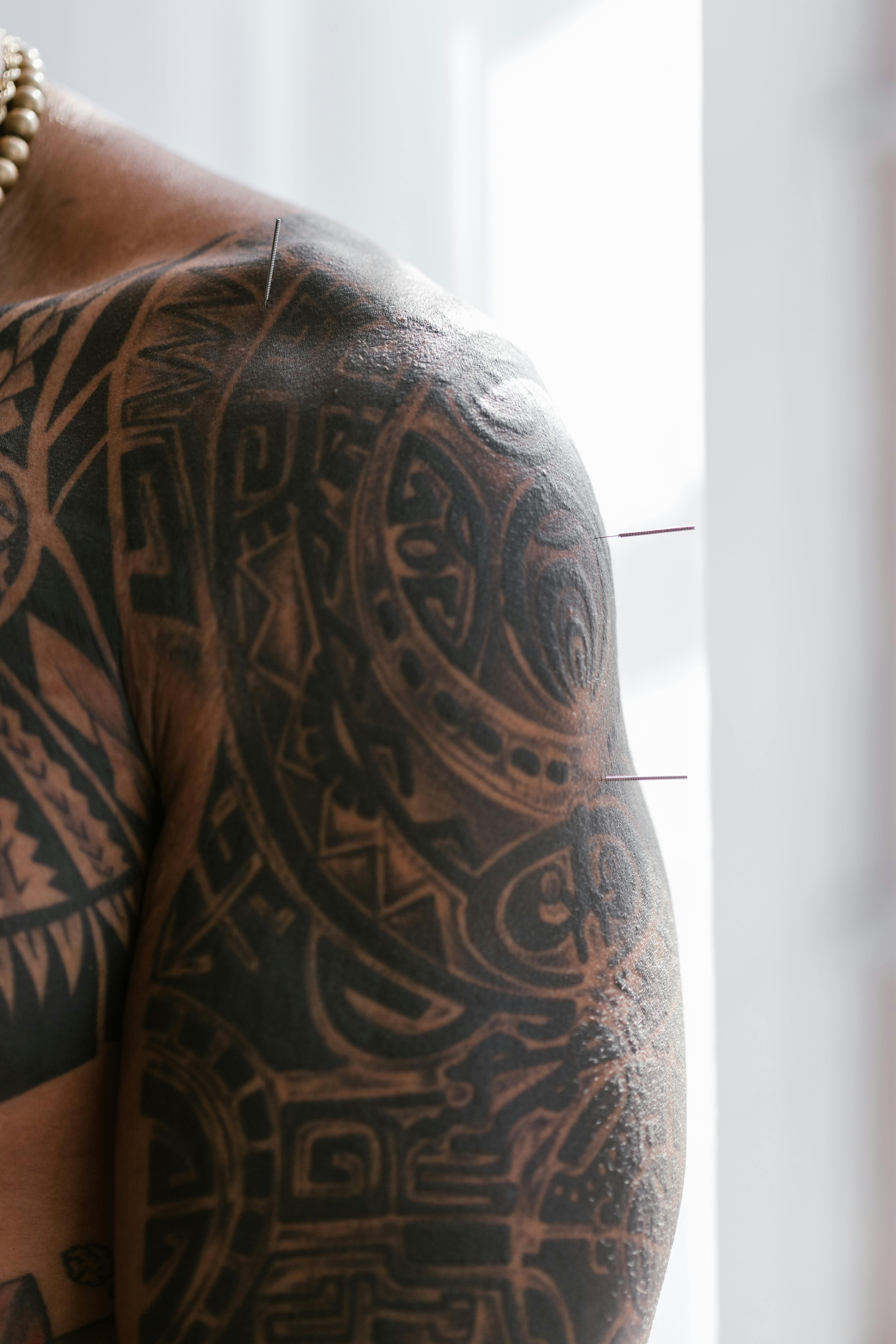 Tribal blackwork sleeve tattoo on shoulder