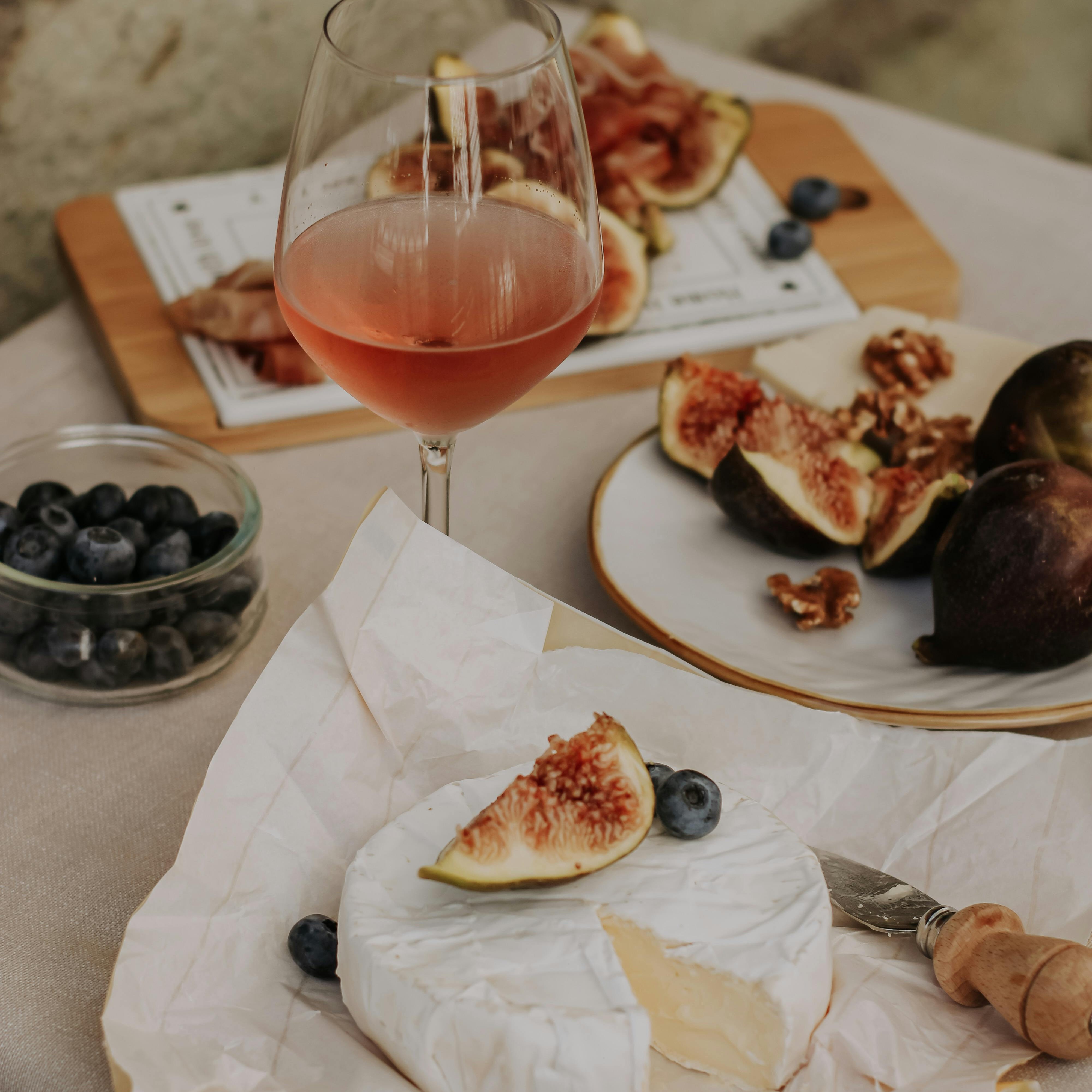 Pair of crystal Burgundy glasses on a polished oak table, late evening, room out of focus